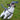 A small black and white dog playing with a blue and white rope toy on a grassy field, leaping as it catches the rope.